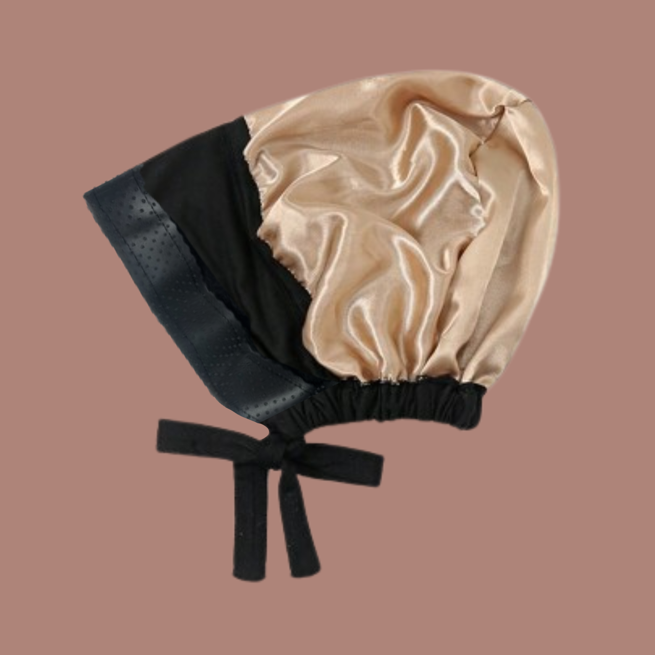 Gold satin non-slip hijab cap with black straps to hold the bun on a pink background