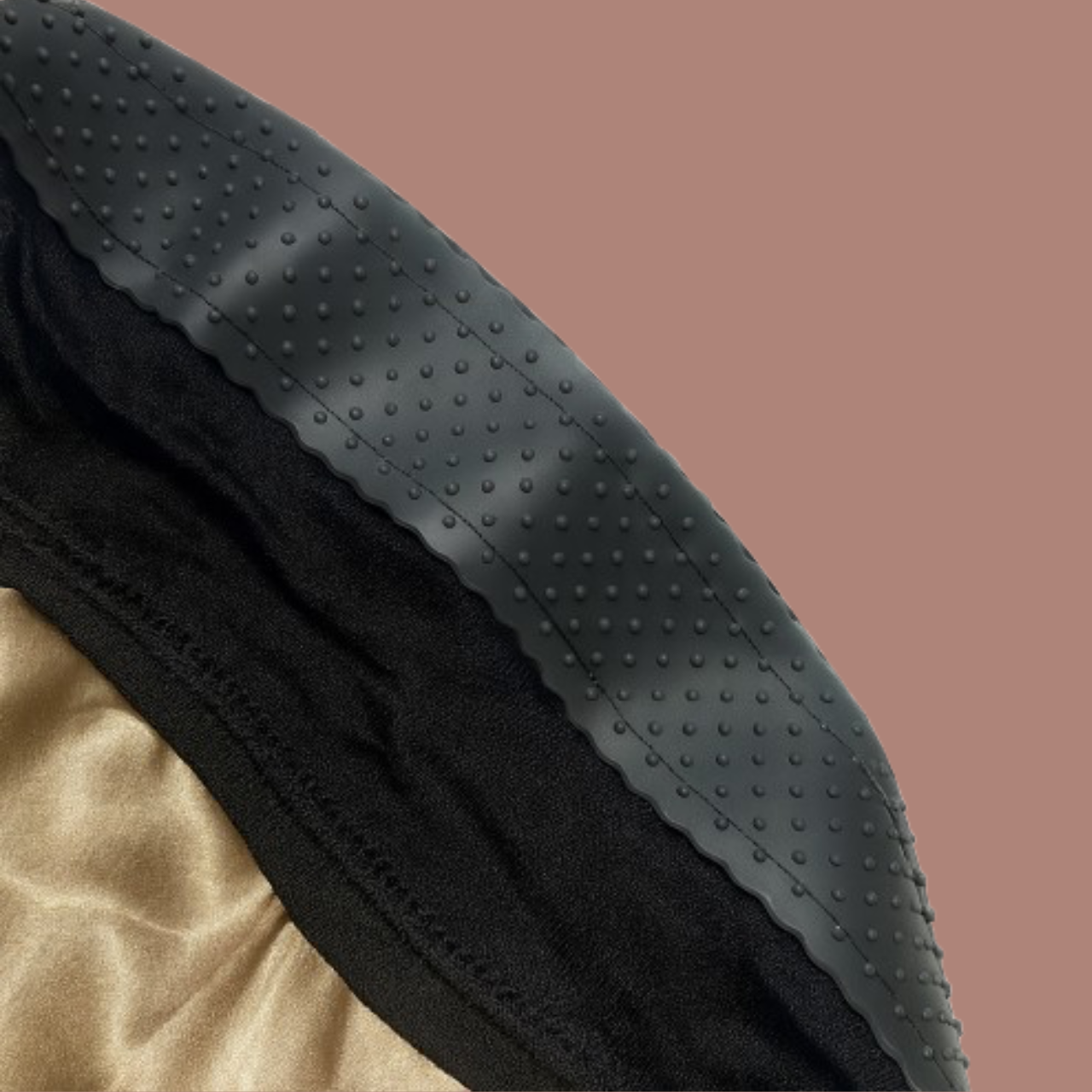 Close-up of black hijab cap with gold satin lining and dotted silicone grip strip to prevent slipping.